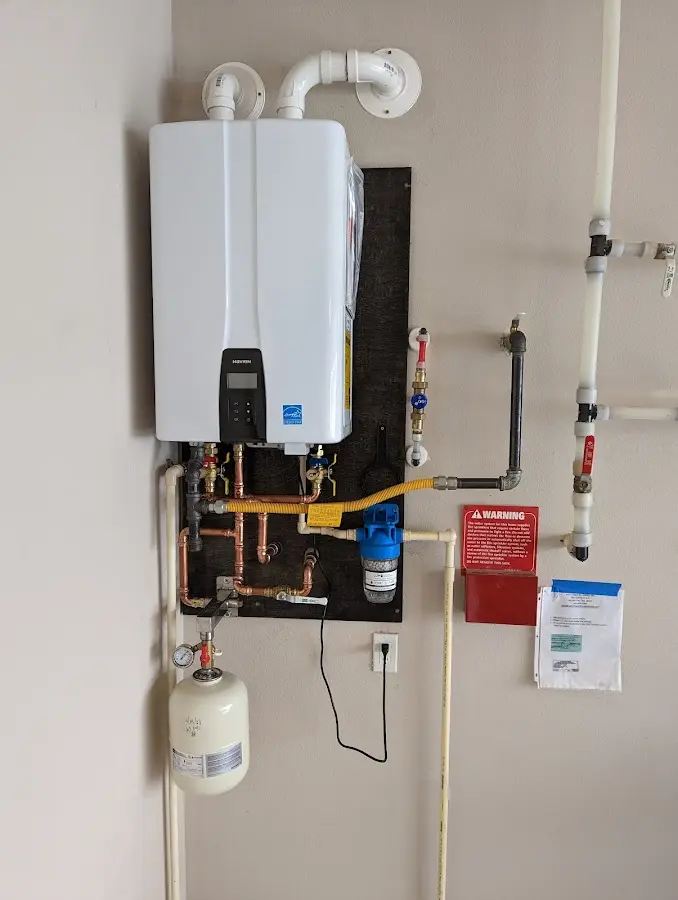 Professional plumber installing copper piping in a Heath home